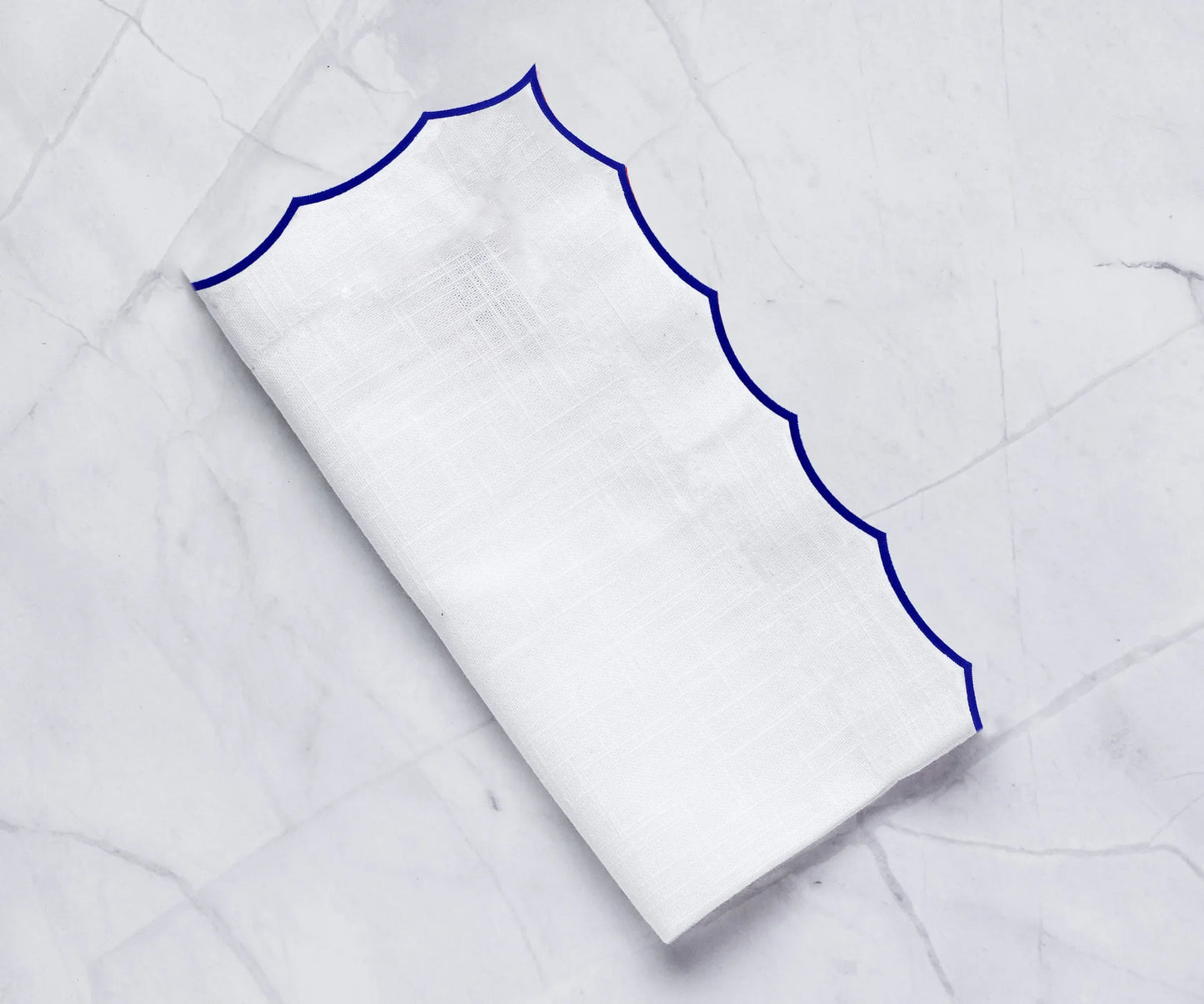 White scalloped napkins for weddings
